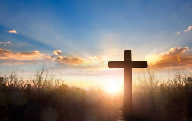 istock Silhouette of catholic cross at sunrise background. 2156302772