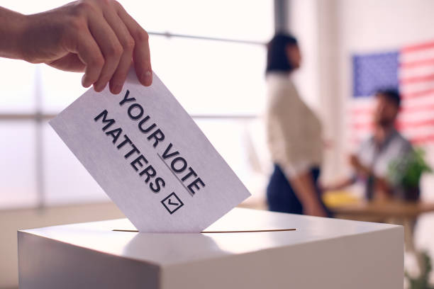 istock Hand Placing Ballot in Box With Your Vote Matters 2156303180