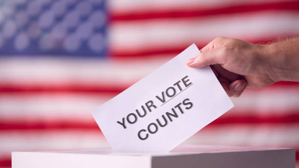 istock Hand Casting Ballot With American Flag 2156303306