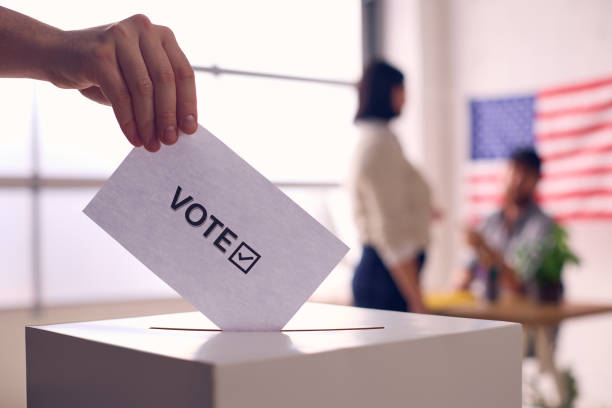 istock Person Voting in Election With Ballot Box 2156303339