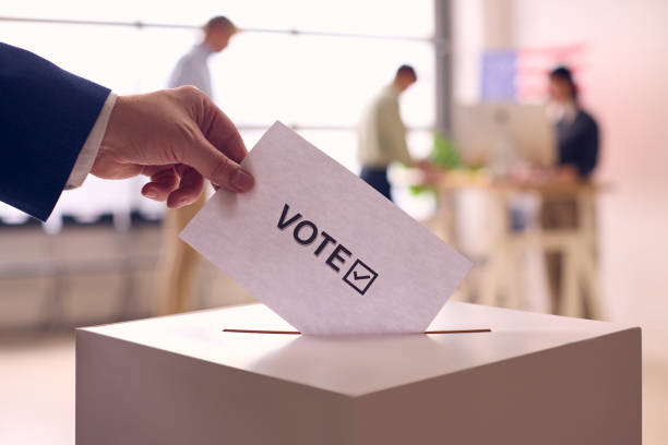 Voter Casting Ballot in Election Booth