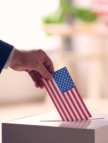 istock Person Casting Ballot With American Flag 2156303567