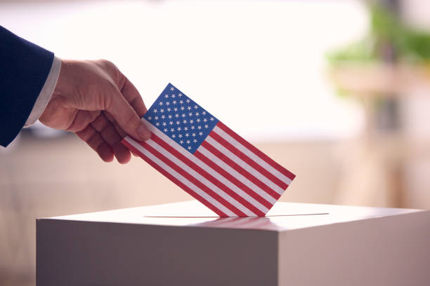 istock Person Casting Ballot With American Flag 2156303745
