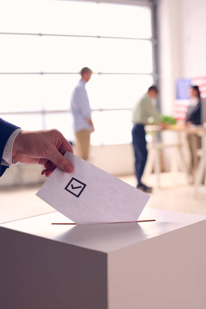 istock Voter Casting Ballot in Election Booth 2156303802