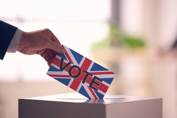 istock Person Voting With UK Flag Ballot 2156303931