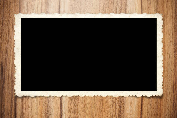 Old blank instant photo frame on wood background. Picture frame.