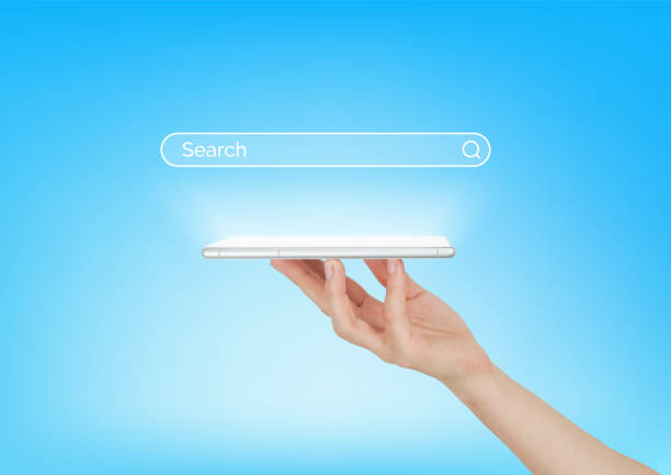 istock Hand holding digital smart phone with search bar hologram on blue background technology copy space 2156306045
