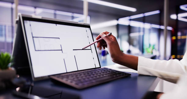 istock African-American Architect Using Digital Tablet to Analyze House Floor Plan 2156306568