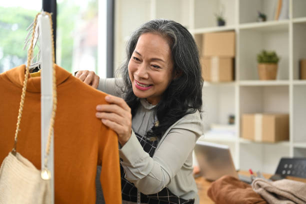 istock Cheerful middle age small business owner working in her clothing store 2156307829