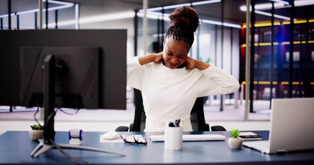 istock Improving Workplace Wellness: African American Woman Suffers from Poor Ergonomics at Office, Impacting Productivity 2156307882