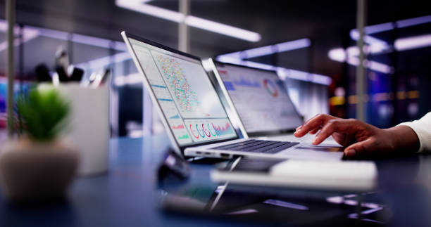 istock Female African American Data Analyst Predicting Market Trends on Virtual KPI Dashboard 2156307941