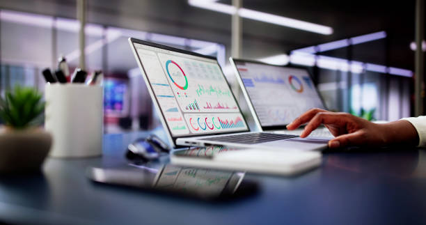 Female African American Data Analyst Predicting Market Trends on Virtual KPI Dashboard Female African American Data Analyst Predicting Market Trends on Virtual KPI Dashboard in Emerging Financial Business Concept. coming out of computer screen stock pictures, royalty-free photos & images