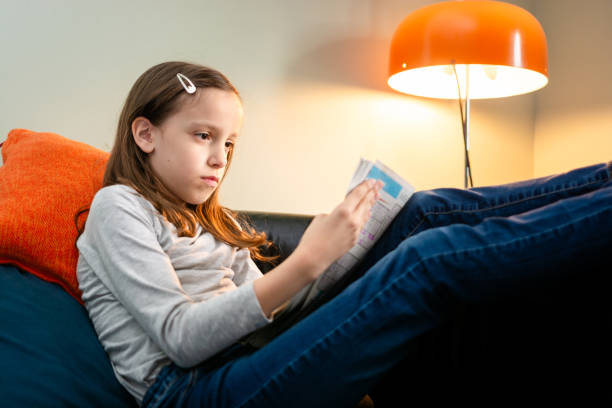 istock Girl relaxing while solving sudoku puzzles from newspaper 2156312994