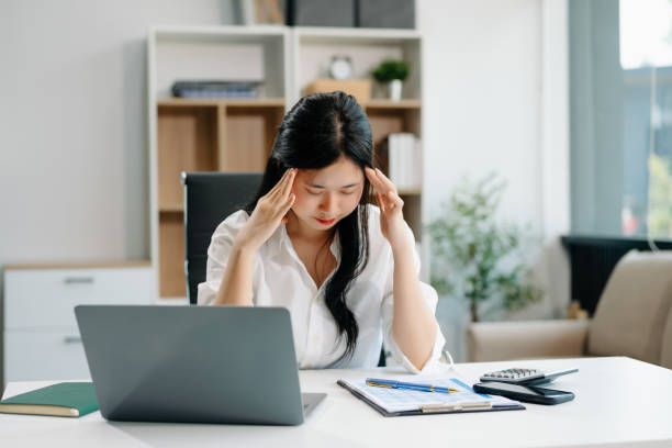 istock Frustrated young businesswoman working on a laptop computer sitting at his working place 2156312995
