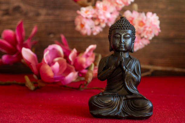 Buddha in atmospheric dark lighting with side light and selective focus