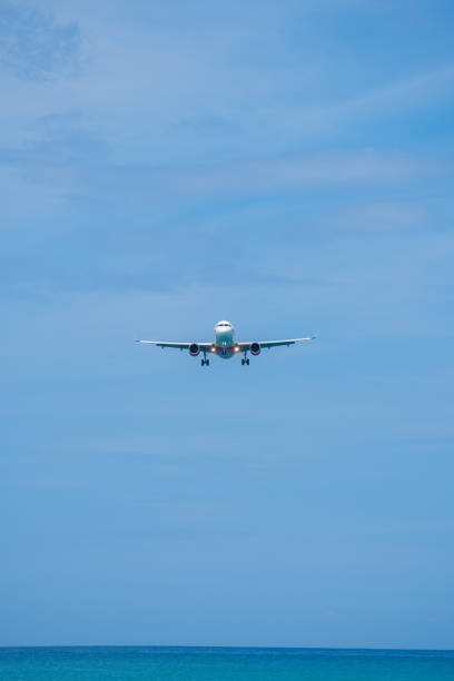 istock plane is landing near white beach and blue sky 2156314380