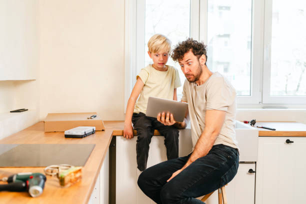 istock Father and son assembling kitchen furniture 2156315333