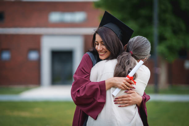 istock Graduate students  embracing on graduation day. 2156317521