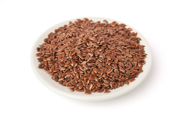 istock Brown flax seeds on white plate isolated on white background. Brown Flax Seed is rich in nutrients such as dietary fiber and essential fatty acids that are beneficial to the body. 2156320620