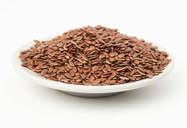 istock Brown flax seeds on white plate isolated on white background. Brown Flax Seed is rich in nutrients such as dietary fiber and essential fatty acids that are beneficial to the body. 2156320629