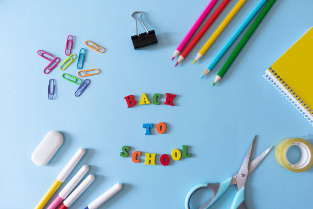 istock back to school blue background with Colourful school supplies 2156323243