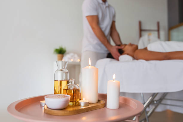 istock Elegant spa setting with candles and oils 2156323529