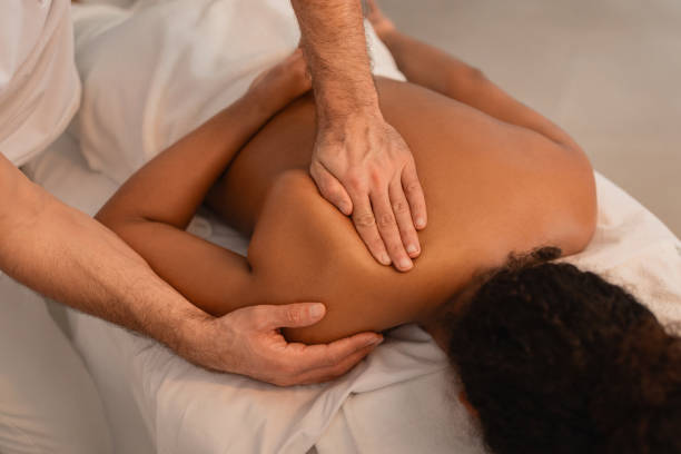 istock Male therapist giving a deep tissue massage 2156323581