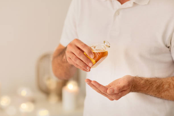 istock Man presenting a bottle of golden oil 2156323601