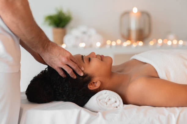 istock Peaceful head massage in candlelit spa treatment room 2156323638