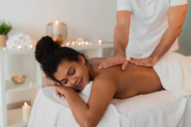 istock Woman enjoying a back massage at spa 2156323671