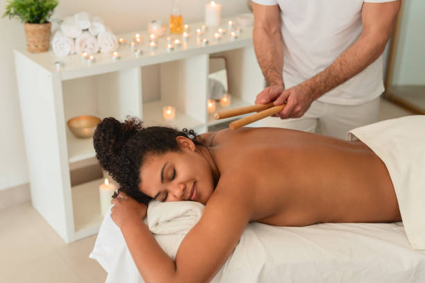 istock Spa therapist using singing bowls near a black lady 2156323737