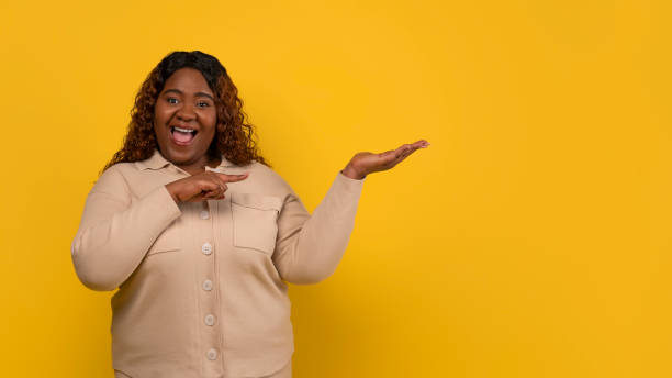 istock Excited young black woman holding something invisible on her palm 2156324247