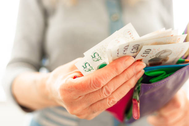 istock Senior woman taking bank notes from her wallet 2156324442