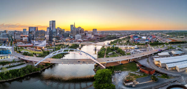 Nashville, Tennessee, USA skyline over the Cumberland River Nashville, Tennessee, USA skyline over the Cumberland River at golden hour. nashville tennessee bridge stock pictures, royalty-free photos & images