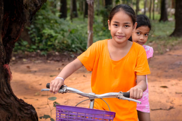 istock Cambodian girls riding a bicycle, Cambodia 2156331175