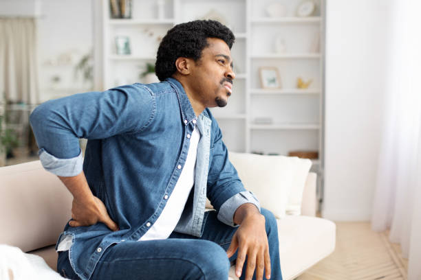 istock Black Man Experiencing Lower Back Pain at Home 2156332347