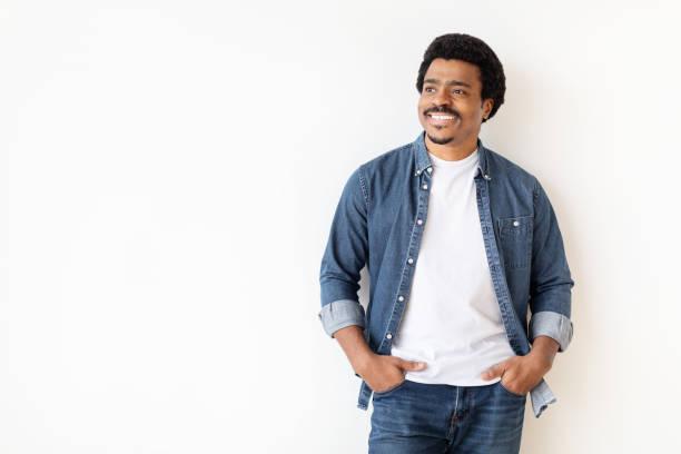 Smiling african american man standing alone on white