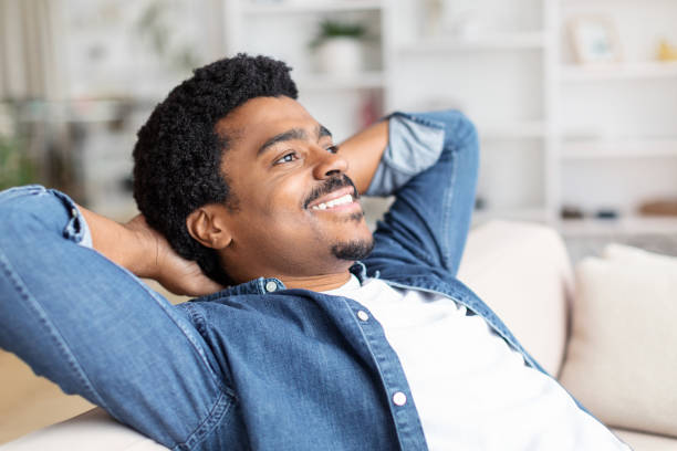 istock Relaxed African American man lying on couch 2156332409