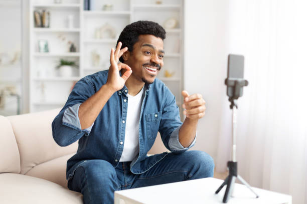 istock Smiling Black Man Making OK Gesture During a Video Call at Home 2156332695