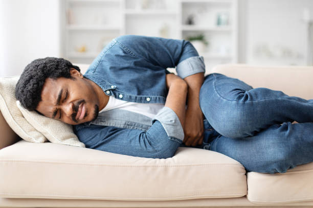istock Casual Young Black Man Suffering From Stomachache at Home 2156332797