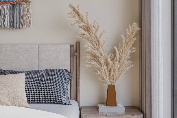 istock Simple cozy white bedroom interior with bedding, bedside table and natural decorations, closeup 2156333806