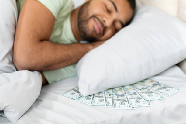 istock Cash scattered on bed signifies financial concept 2156334292