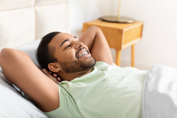 istock Man Laying in Bed With Head on Pillow 2156334349