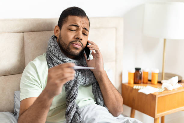 istock Young Man Wrapped in Scarf Making a Phone Call 2156334354