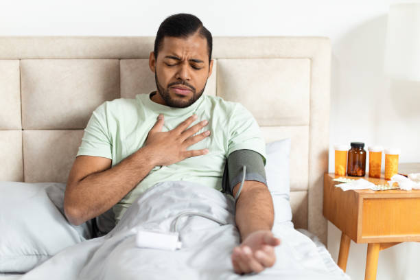 istock Man Experiencing Chest Pain While Resting in Bed at Home 2156334357