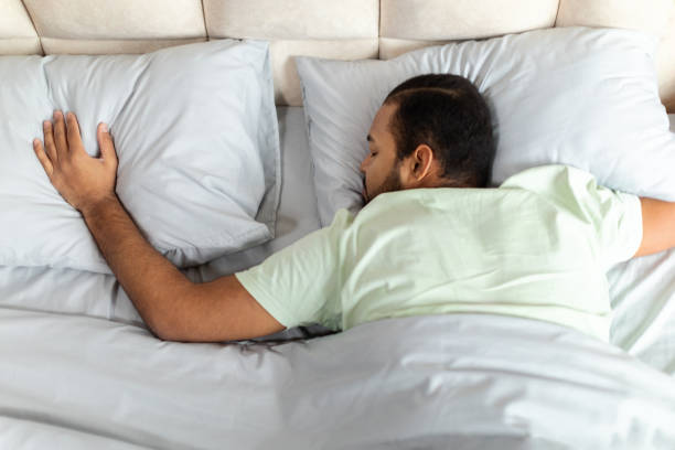 istock Top view of peaceful black man sleeping in comfy bed 2156334380