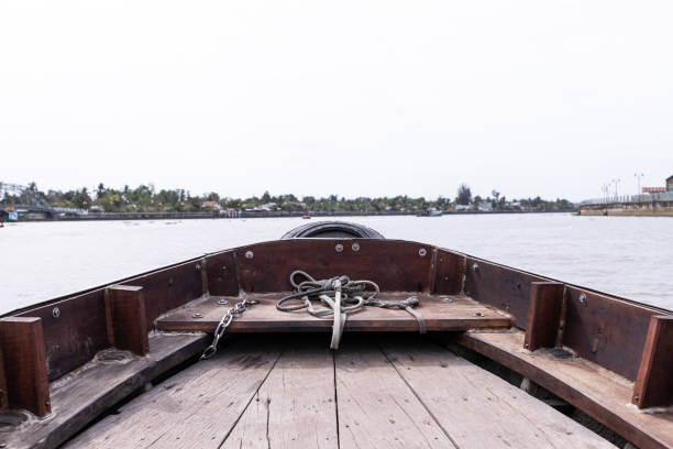 Views from the front of a wooden boat navigating the mekong delta in Vietnam.