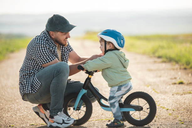 istock Dad prepared his toddler for a bicycle ride. 2156335421