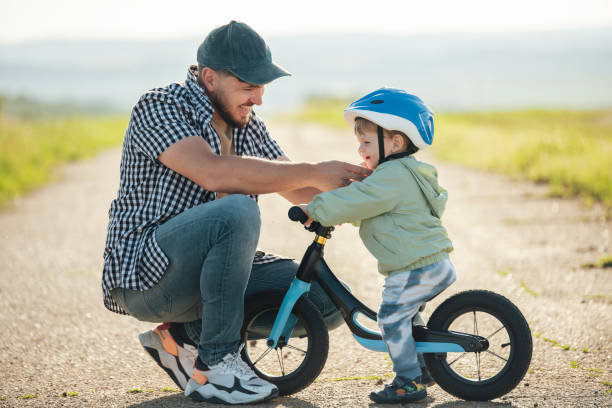 istock Dad prepared his toddler for a bicycle ride. 2156335428