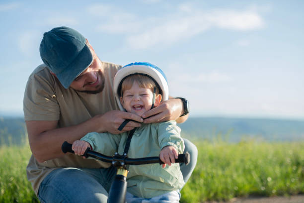 istock Father preparing his little boy for a bicycle ride. 2156335451